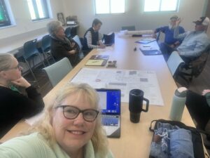 Board members around a table during a construction meeting
