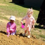 children in pink digging in the dirt