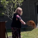 Norma Honeycutt, executive director of Partners in Learning, with a shovel of dirt