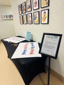 banner and papers to sign spread the word to end the word